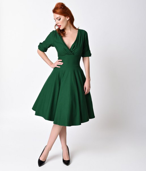 mörkgrön gungklänning med djup V-ringning i stil med 1950-talet
